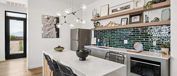 A modern kitchen with a white countertop and a stainless steel oven.