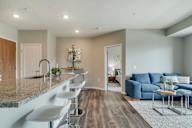 Open floor plan with kitchen, dining and living room at Ascend at Woodbury MN 55129 new luxury apartments