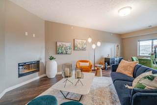 Spacious living room with modern fireplace at The Flats at Shadow Creek new luxury apartments in east Lincoln NE 68520