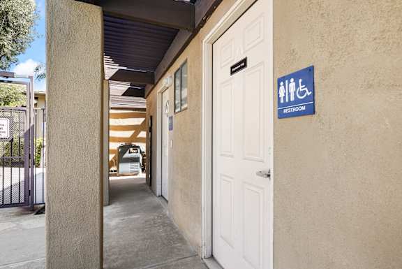 the entrance to a building with a white door and a sign that reads hhs