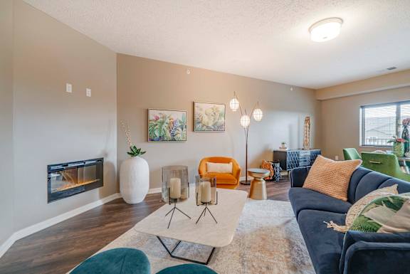 Spacious living room with modern fireplace at The Flats at Shadow Creek new luxury apartments in east Lincoln NE 68520