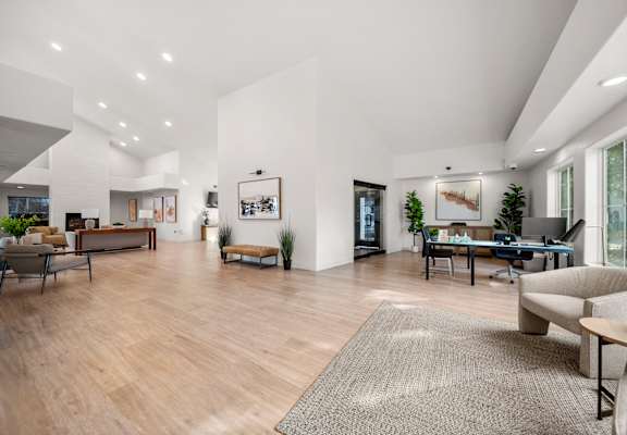 A spacious living room with wooden floors and furniture.