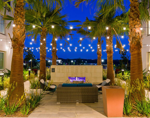 Lounge area with palm trees and a fountain at Sola, San Diego, 92130