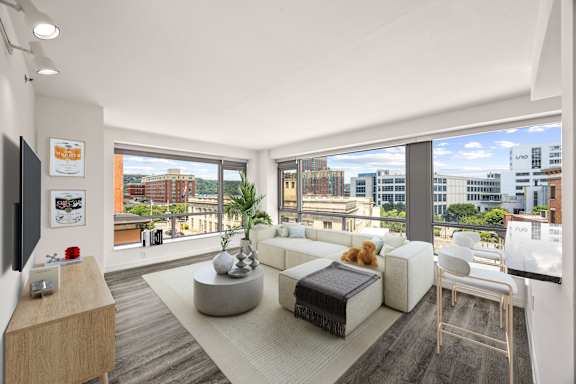 A modern living room with a large window overlooking the city.