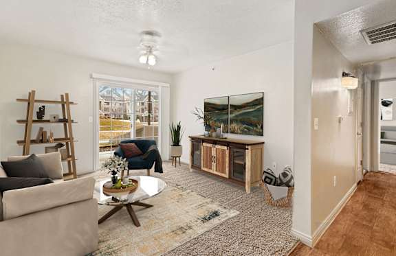 A living room with a couch, coffee table, and a painting on the wall.