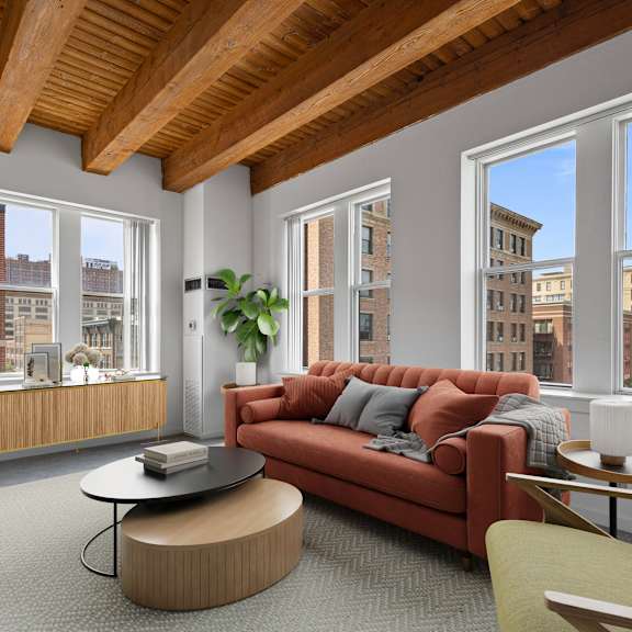 A living room with a red couch and a coffee table.