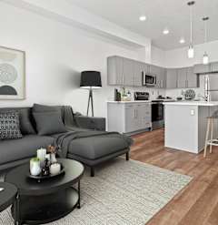 a living room with a large window and a couch and chairs