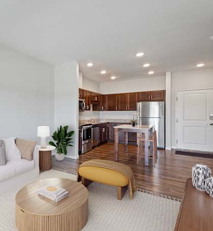 A modern living room with a white sofa and a yellow ottoman.