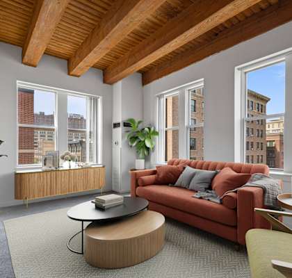 a living room with a red couch and a large window