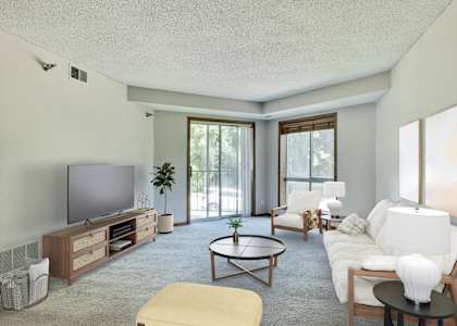 A living room with a television, couch, and coffee table. at Crosby Pointe Apartments, St. Paul , MN, 55116-3244