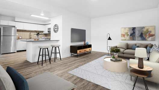 A modern living room with a bar and a kitchen in the background.