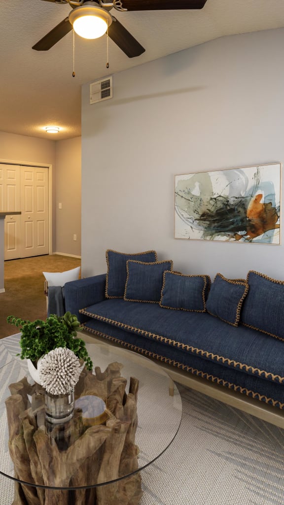 a living room and dining room with a table and chairs and a kitchen in the background at Ashton Oaks, New Port Richey, 34654