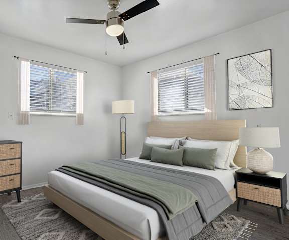 A bedroom with a large bed and a painting on the wall.