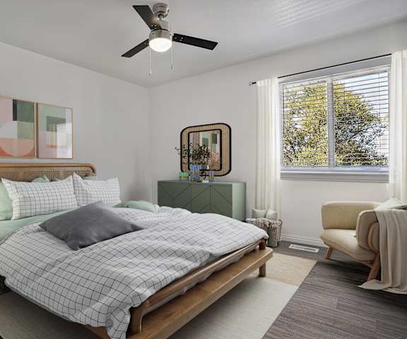 A bedroom with a bed, nightstand, chair, and a ceiling fan.