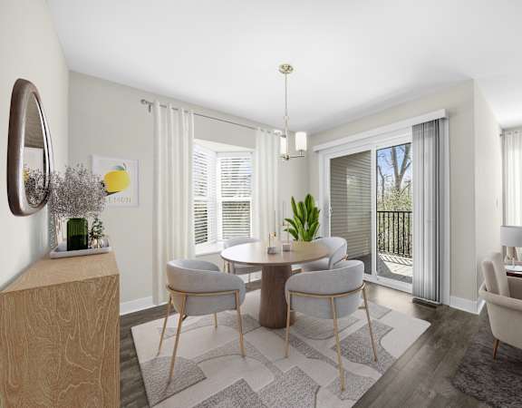 A modern dining room with a round table and chairs.