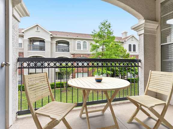 A patio with a table and two chairs is shown.