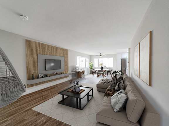 A modern living room with a brown sofa and a television at Oasis Apartments, Burbank, CA