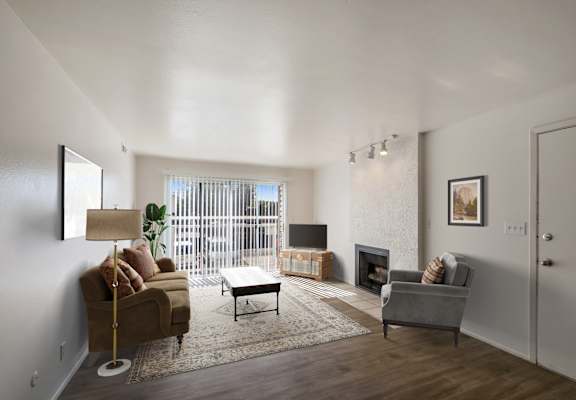 a living room with a couch and a chair and a fireplace