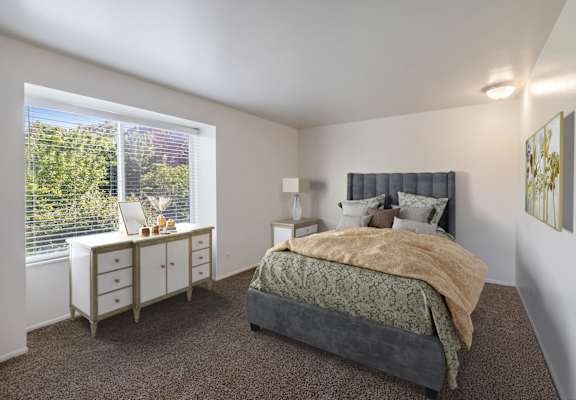 a bedroom with a bed and a large window