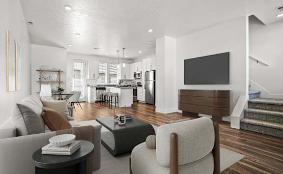 an open kitchen and living room with a leather couch