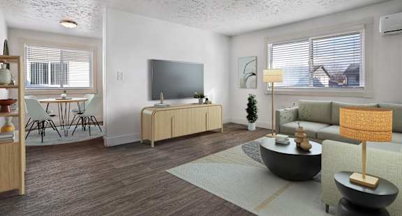 A living room with a television, a sofa, and a coffee table.