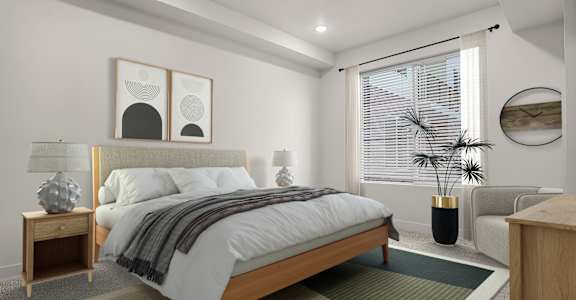 A bedroom with a large bed and a potted plant.