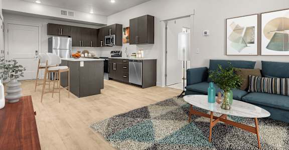 A modern kitchen with a dining table and a couch.