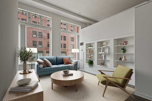 A living room with a blue couch and a green chair.