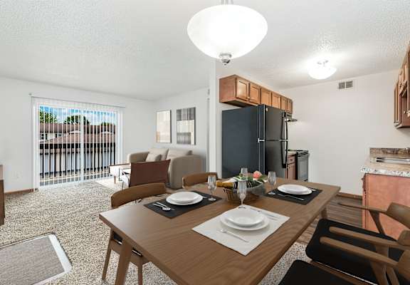 A dining room with a table set for two.