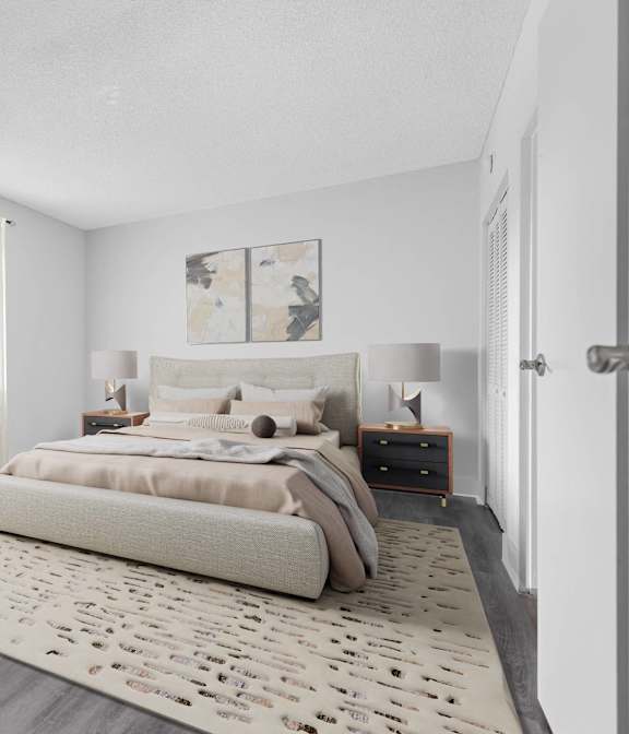 A bedroom with a large bed and a plant.