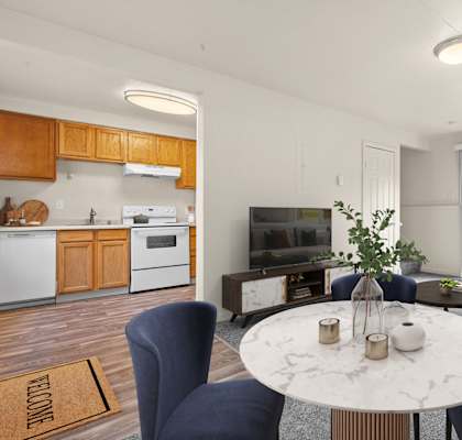 A modern kitchen with a dining table set for two.