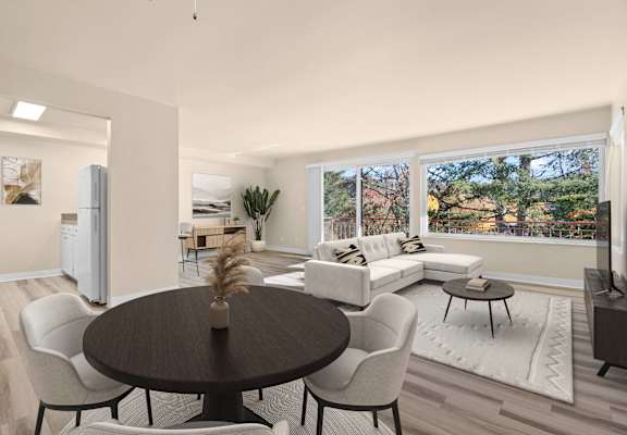 A modern dining room with a round table and chairs.
