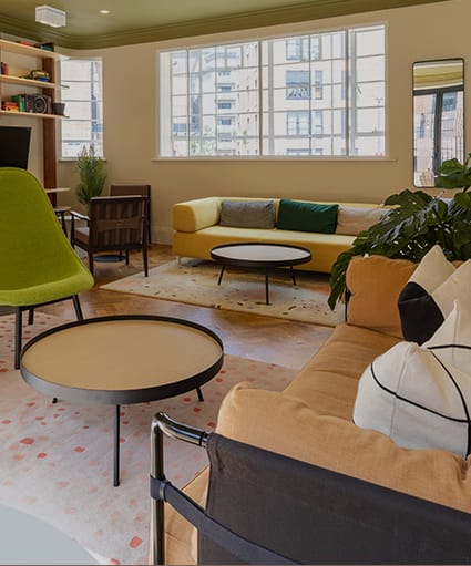 a lobby with a staircase and a table and chairs