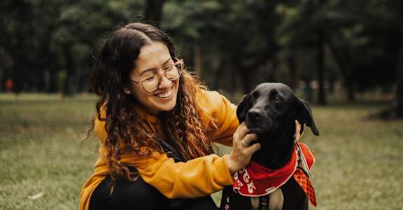 a woman and her dog in a park