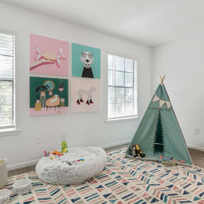 a bedroom with a teepee and a bean bag chair