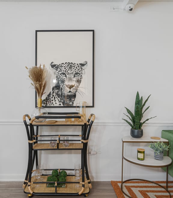a room with a desk and a leopard on the wall