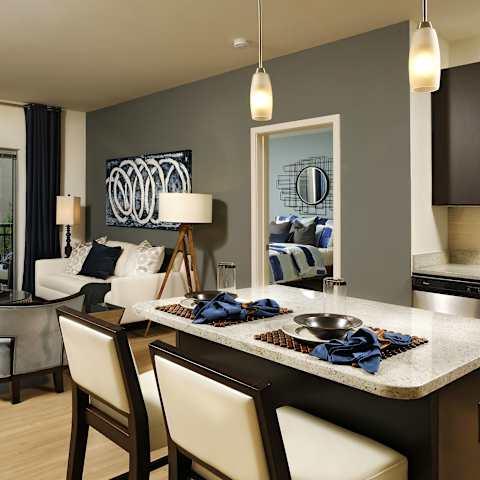 a kitchen and living room with a table and chairs