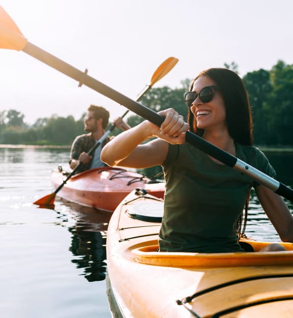a group of people kayaking on a lake in their kayaks