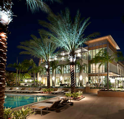 A modern house with a pool and palm trees at Circa 37 Apartments, San Diego, CA