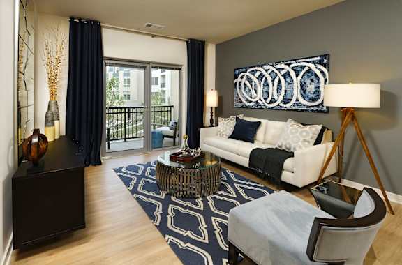 a living room with a white couch and a rug