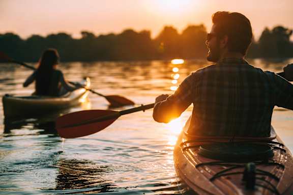 A man and a woman kayaking on a lake during sunset.at The Ace, Richmond, 23230