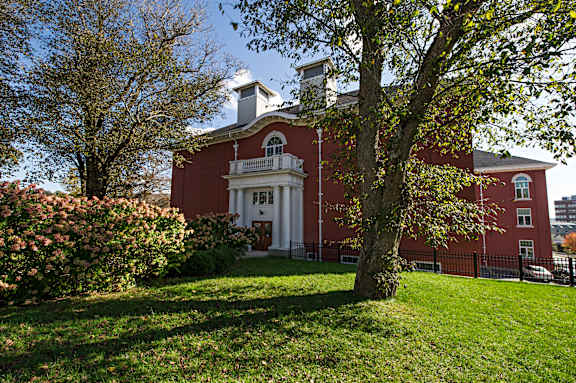 A red building with a white door and windows.