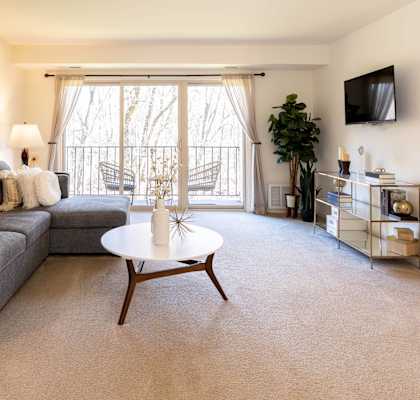a living room with a gray couch and a white coffee table