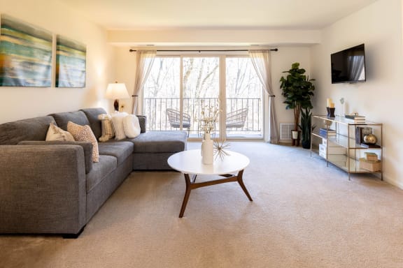 a living room with a gray couch and a white coffee table