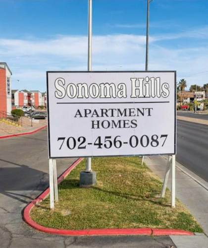 A sign for Sonoma Hills Apartment Homes stands in front of a street.