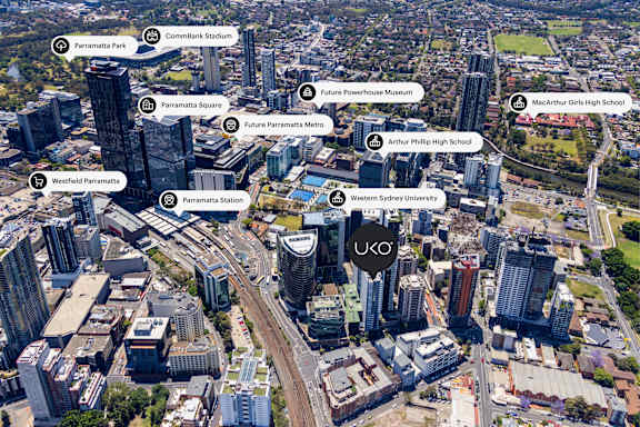 An aerial view of a city with buildings and roads labeled with names such as Parramatta Park, Commbank Stadium, and Western Sydney University.
