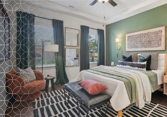 A bedroom with a bed, chair, and a rug.