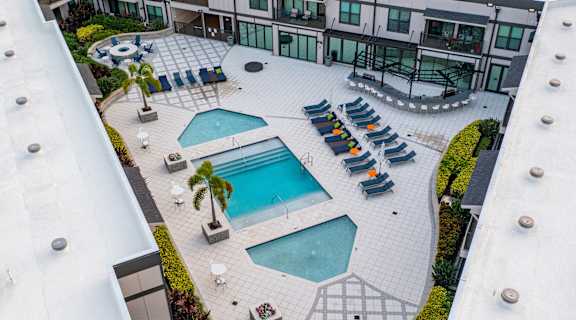an aerial view of a pool and patio area of a hotel