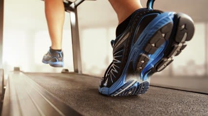 a person running on a treadmill in a gym