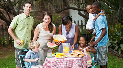 Families having an outdoor picnic